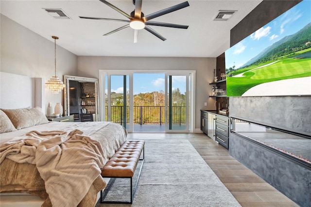 bedroom with light hardwood / wood-style floors and access to outside