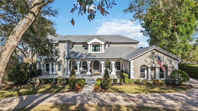 view of front of property with covered porch and a front yard