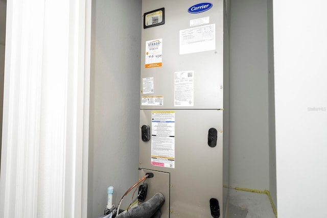 utility room featuring heating unit