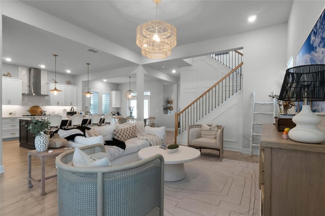 living room with light wood-type flooring and a chandelier