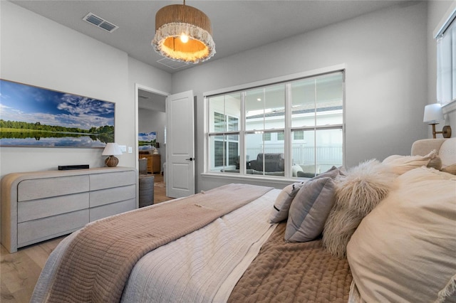 bedroom featuring light hardwood / wood-style floors and multiple windows