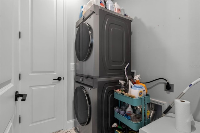 laundry room with stacked washer / drying machine