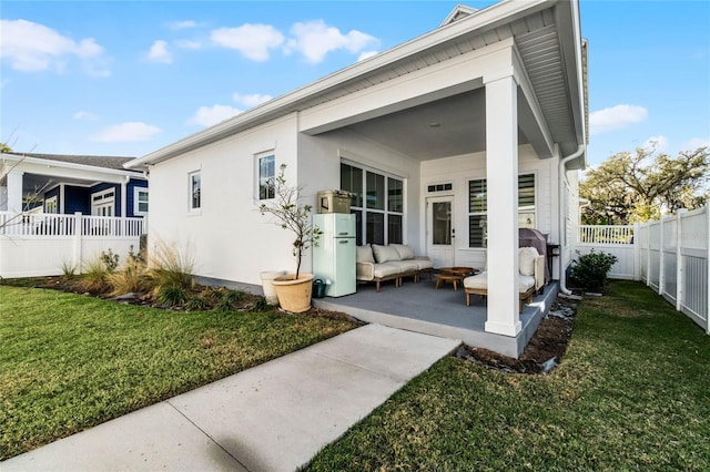 back of house with a yard, a patio, and an outdoor hangout area