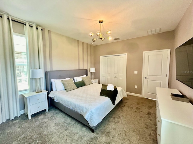 carpeted bedroom featuring a chandelier and a closet