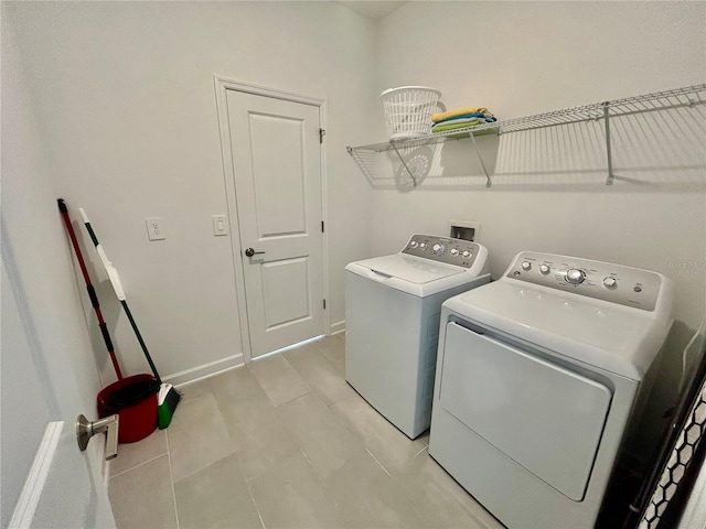 clothes washing area featuring independent washer and dryer