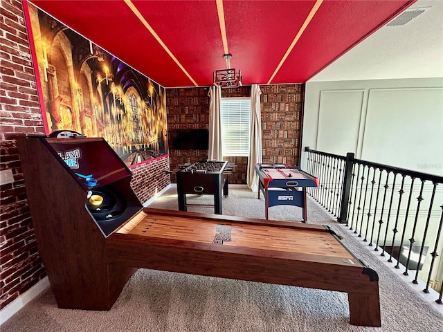 playroom with carpet and brick wall