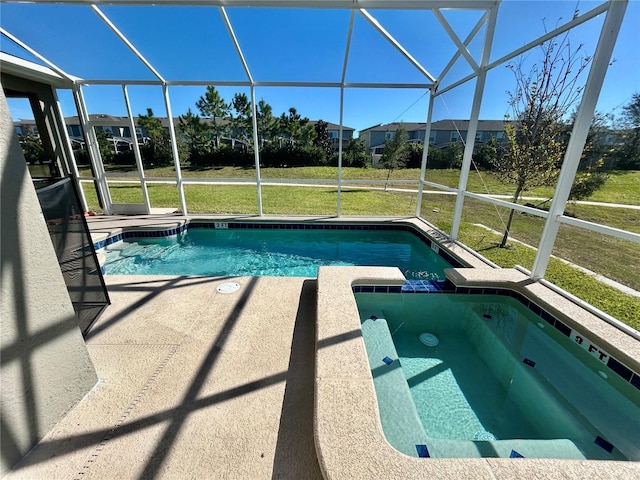 view of swimming pool with glass enclosure, a patio area, and a lawn