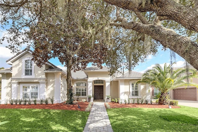 mediterranean / spanish house with a front lawn