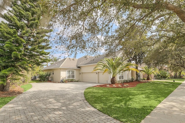 view of front of property with a garage and a front lawn