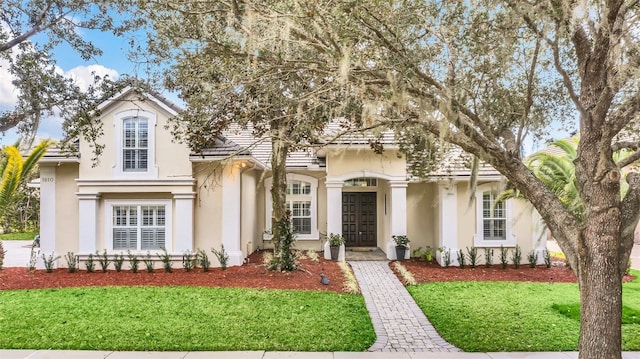 1610 Conway Isle Cir, Belle Isle, FL 32809 - view of front facade with stucco siding, a front yard, french doors, and a tiled roof