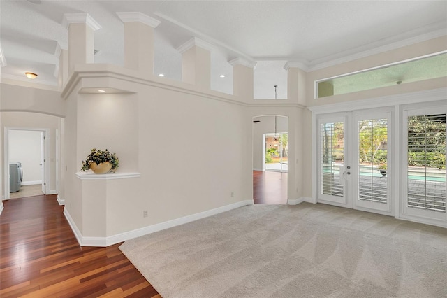 1610 Conway Isle Cir, Belle Isle, FL 32809 - unfurnished room featuring arched walkways, ornamental molding, a high ceiling, and wood finished floors