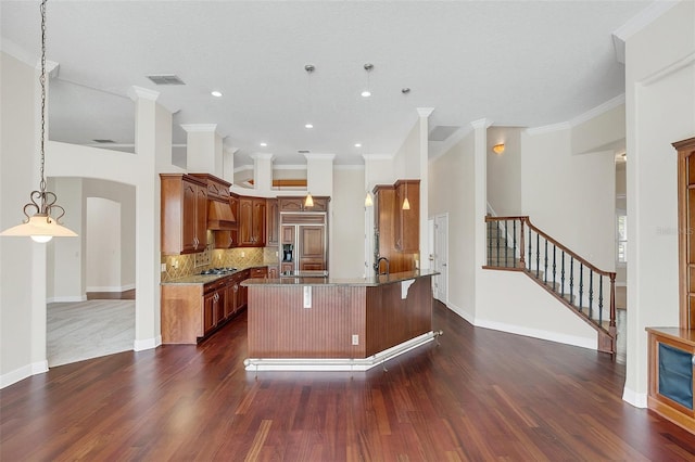 kitchen with backsplash, a kitchen breakfast bar, dark hardwood / wood-style floors, paneled built in refrigerator, and ornamental molding