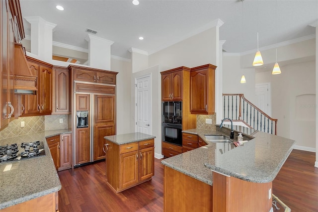 1610 Conway Isle Cir, Belle Isle, FL 32809 - kitchen with black appliances, a peninsula, light stone counters, dark wood finished floors, and decorative backsplash
