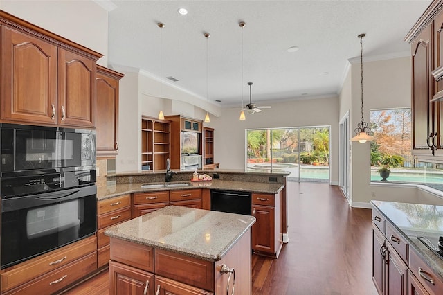 1610 Conway Isle Cir, Belle Isle, FL 32809 - kitchen with black appliances, a peninsula, dark wood finished floors, ceiling fan, and crown molding