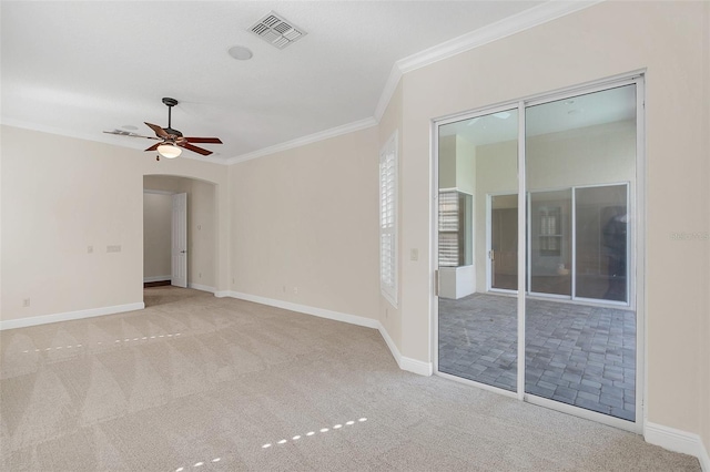 carpeted spare room featuring ceiling fan and crown molding