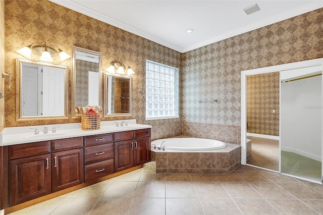 1610 Conway Isle Cir, Belle Isle, FL 32809 - bathroom featuring a garden tub, double vanity, tile patterned flooring, and crown molding
