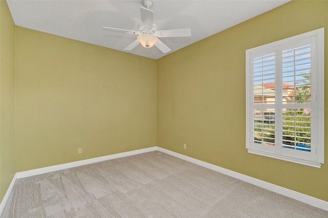 empty room with light carpet and ceiling fan