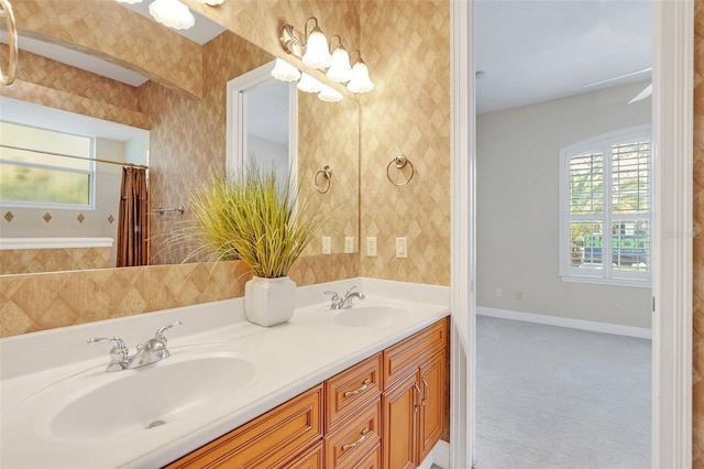 1610 Conway Isle Cir, Belle Isle, FL 32809 - bathroom with double vanity, wallpapered walls, and a shower with curtain