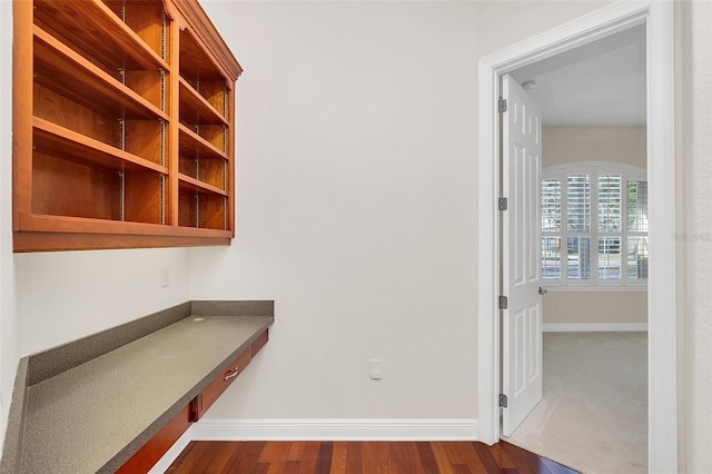 hallway with dark wood-type flooring