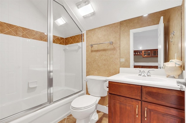 full bathroom featuring tile patterned flooring, vanity, toilet, and enclosed tub / shower combo