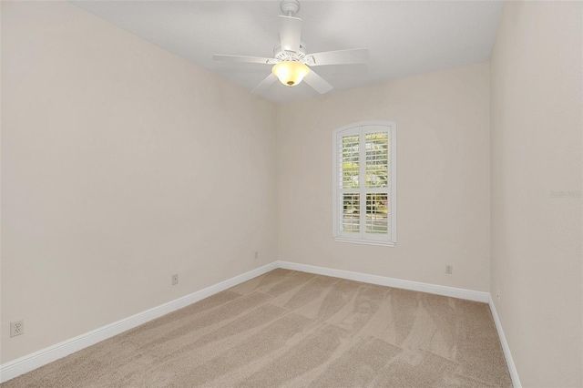 unfurnished room featuring ceiling fan and light carpet