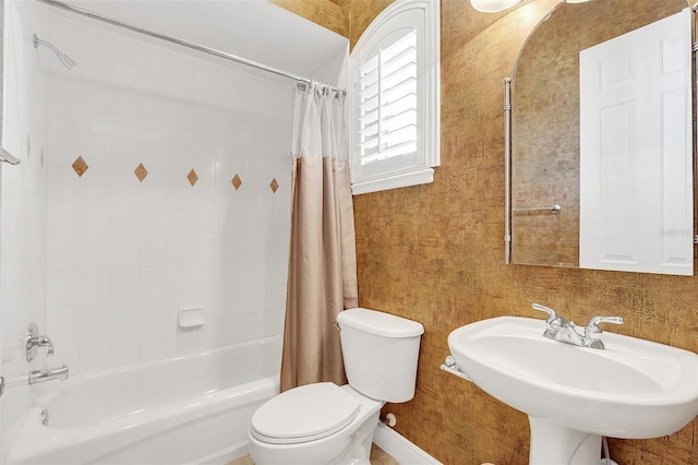 full bathroom featuring toilet, shower / bathtub combination with curtain, and sink