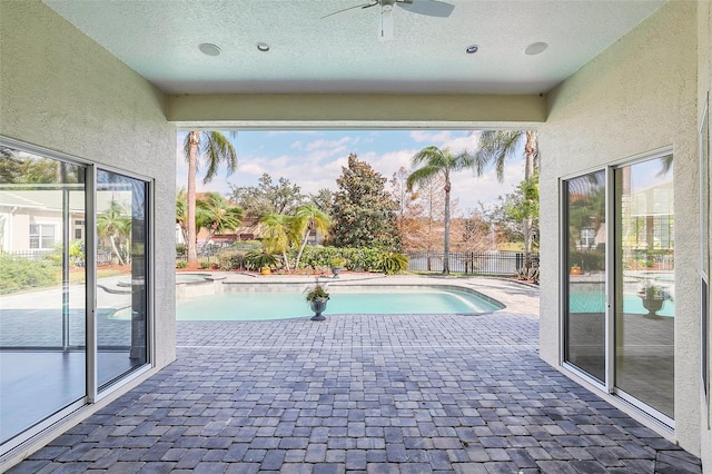 view of pool with a patio and ceiling fan