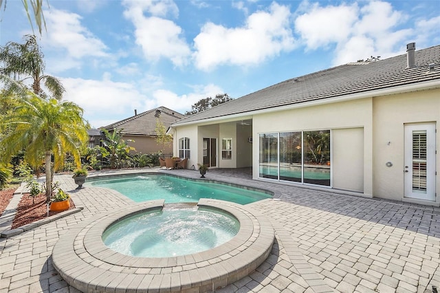 view of swimming pool with an in ground hot tub and a patio