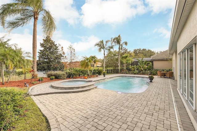 view of swimming pool with an in ground hot tub and a patio