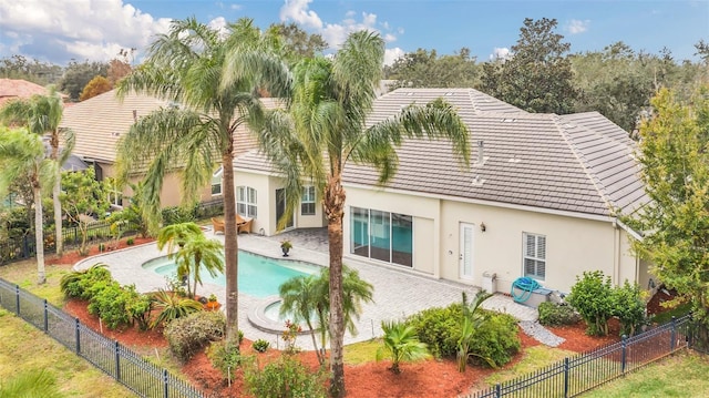 exterior space featuring a pool with hot tub and a patio