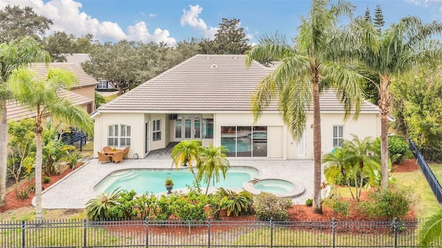 1610 Conway Isle Cir, Belle Isle, FL 32809 - rear view of property featuring stucco siding, a tiled roof, a patio area, a fenced backyard, and a pool with connected hot tub