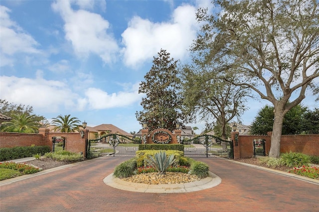 1610 Conway Isle Cir, Belle Isle, FL 32809 - view of decorative road with a gate, curbs, and a gated entry
