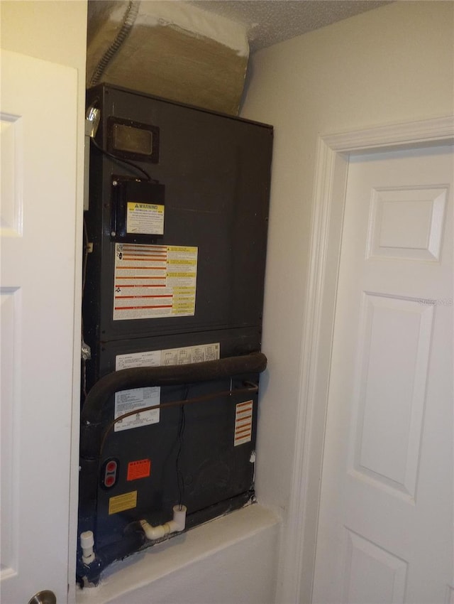 utility room featuring heating unit