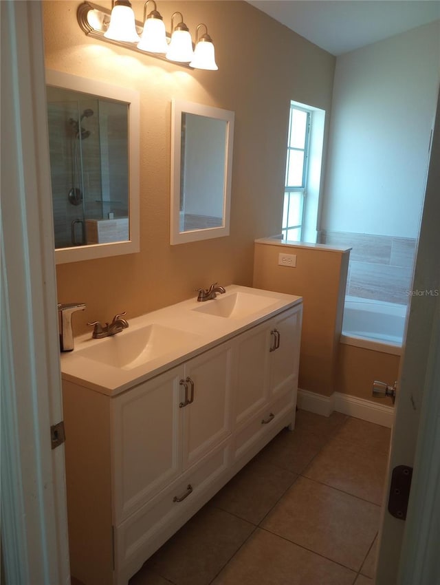 bathroom with tile patterned flooring, vanity, and a tub to relax in