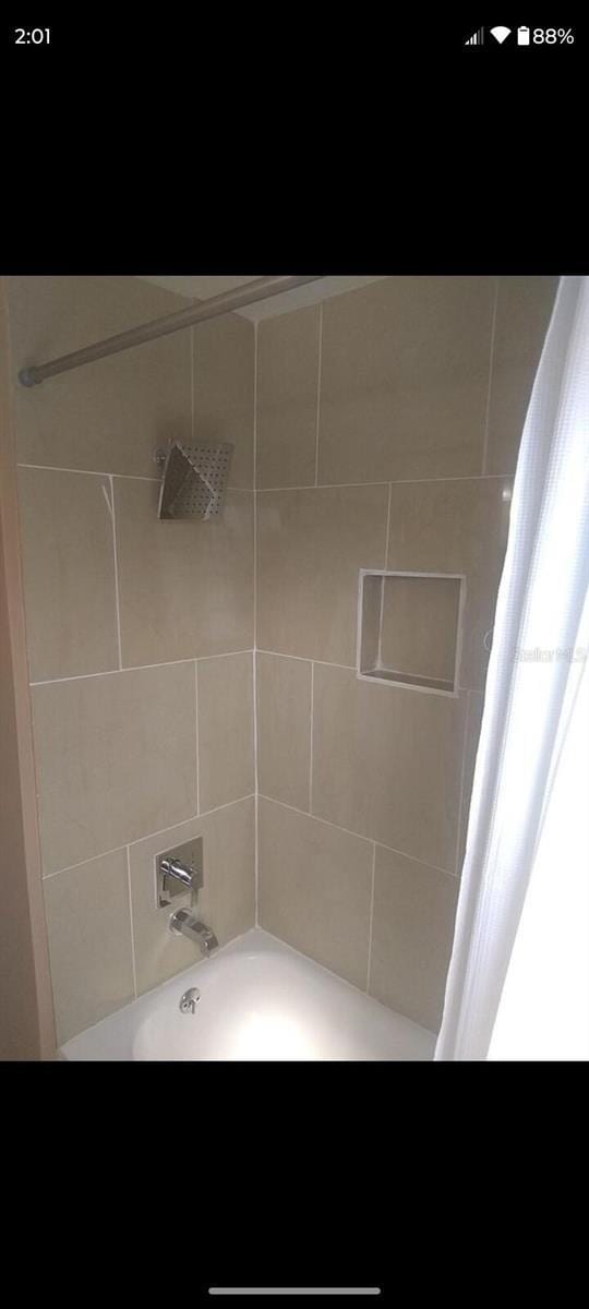 bathroom with shower / bathtub combination with curtain