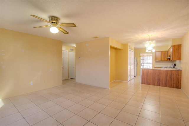 79 Lake Villa Way, Kissimmee, FL 34743 - unfurnished living room with a chandelier, ceiling fan, and light tile patterned floors