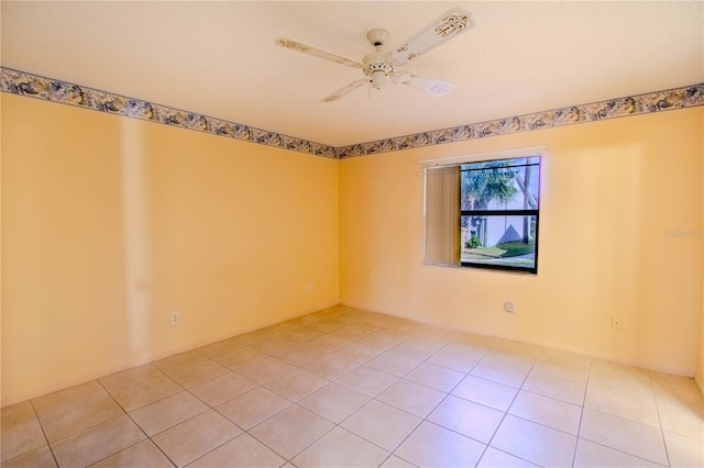 spare room featuring ceiling fan and light tile patterned floors