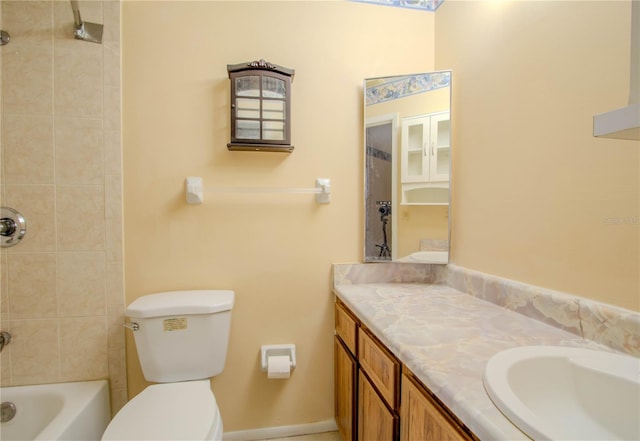 full bathroom with vanity, toilet, and tiled shower / bath