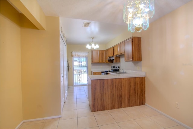 kitchen featuring hanging light fixtures, an inviting chandelier, kitchen peninsula, stainless steel electric range, and light tile patterned flooring