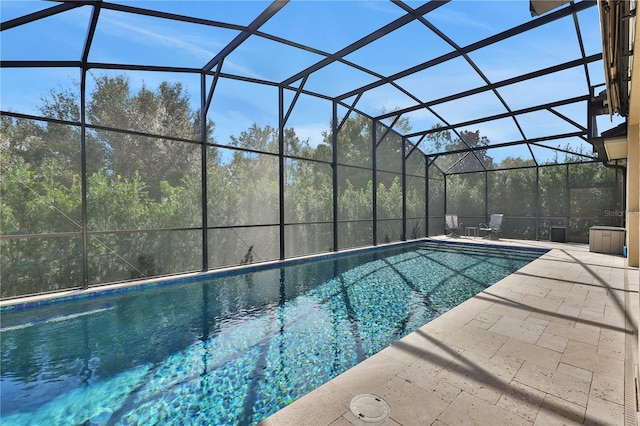 view of swimming pool featuring a patio area and a lanai