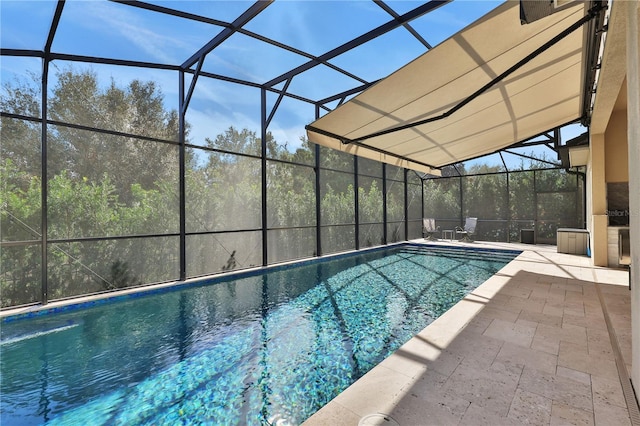 view of swimming pool featuring a lanai and a patio area