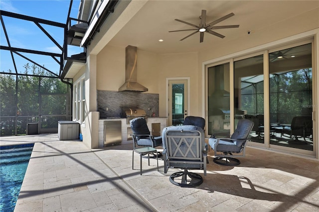 view of patio with an outdoor kitchen, area for grilling, and ceiling fan