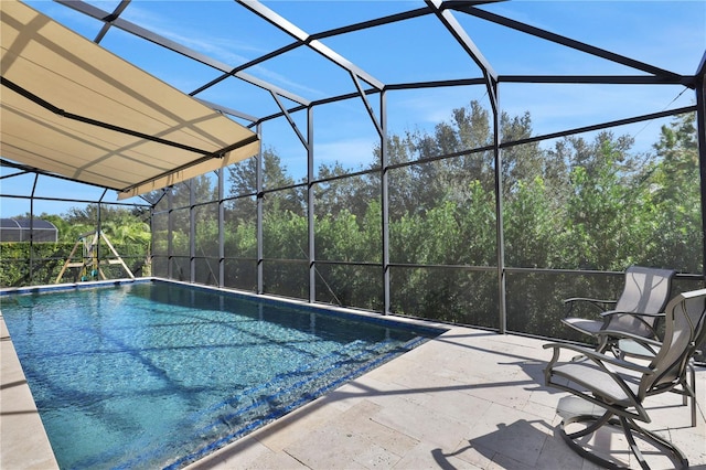 view of swimming pool featuring a lanai and a patio