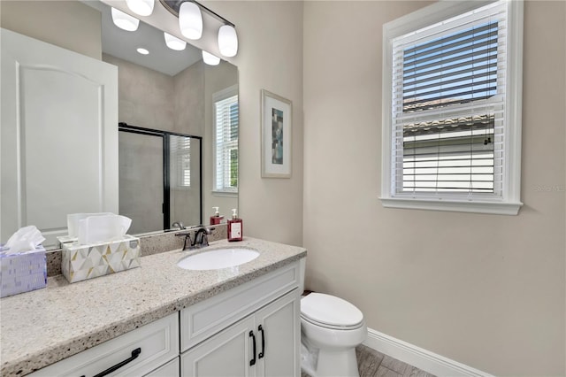 bathroom featuring vanity, toilet, and walk in shower