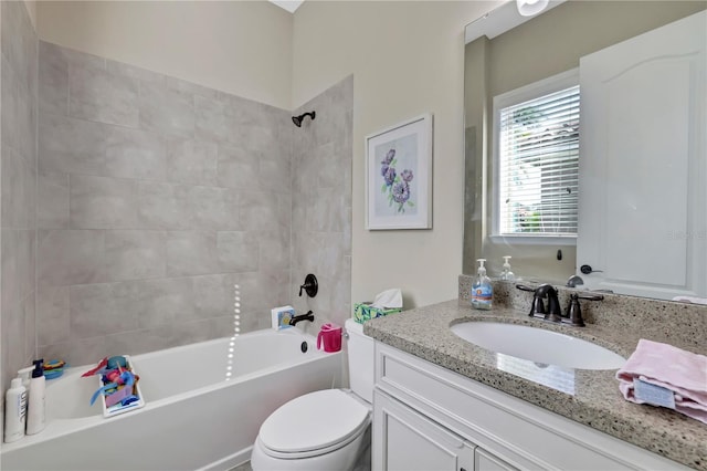 full bathroom with toilet, vanity, and tiled shower / bath