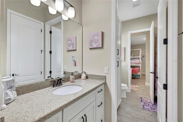 bathroom with vanity and toilet