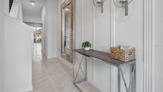 corridor featuring light tile patterned floors