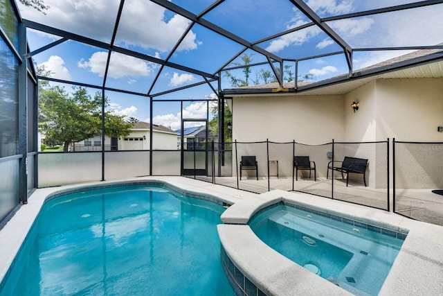 view of swimming pool featuring a lanai, a patio area, and an in ground hot tub