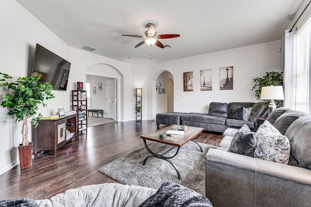 living room with dark hardwood / wood-style floors and ceiling fan