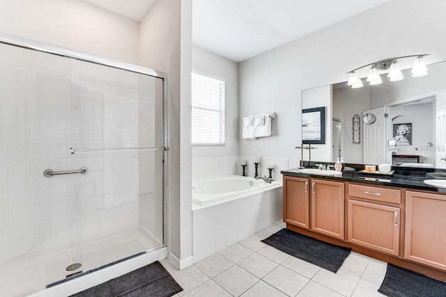 bathroom with tile patterned flooring, vanity, and independent shower and bath